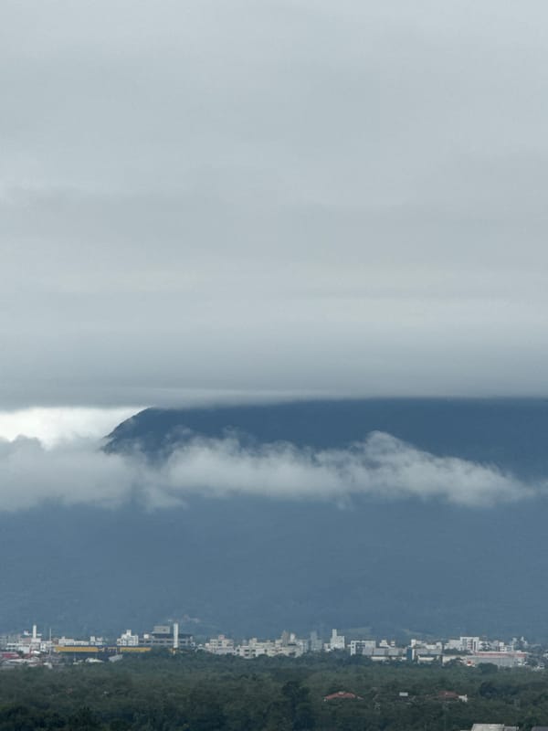 Cloud-covered mountain landscape with a village on the hillside