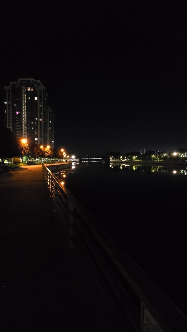 Evening views of illuminated Kyiv waterfront apartments along Dnipro River