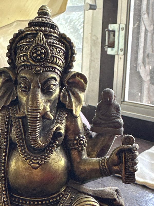 Bikes, Ganesha statues, and street artifacts in Karon