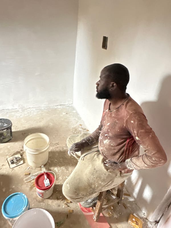Construction worker renovates interior room in Bukuru, Nigeria