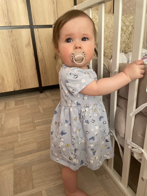 Baby in yellow elephant onesie photographed in Chaikovsky