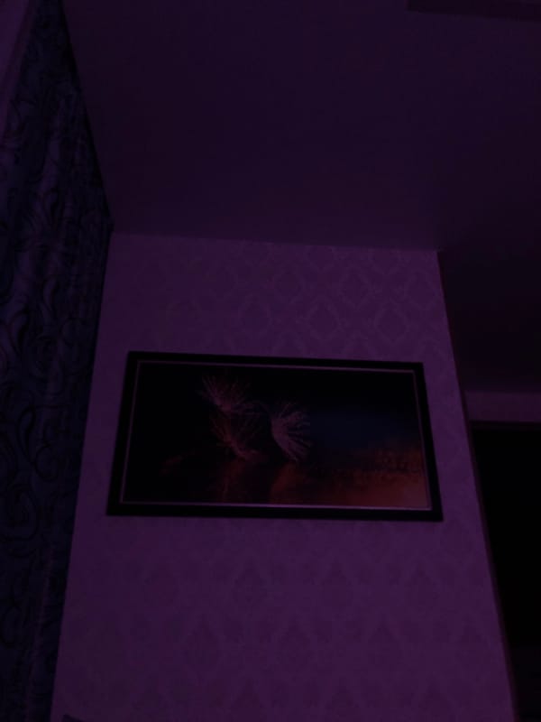 Witness captures dimly lit interior with screens, staircase