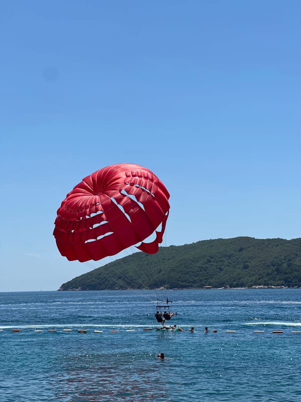 Summer morning in Budva: parasailing, coffee, and Adriatic beach vibes