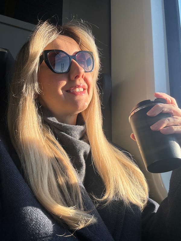 Woman works on laptop during early morning commute in Riga