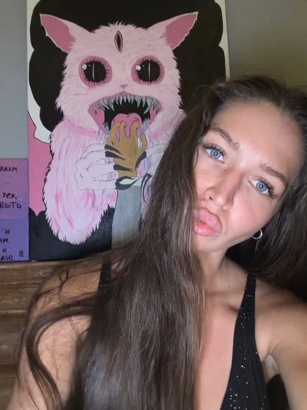 Woman poses with cartoon monster artwork in Canggu