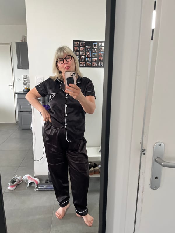 Woman takes playful mirror selfie in pajamas