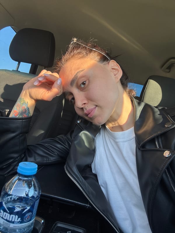 Woman in leather jacket photographed in car, Tbilisi landscapes