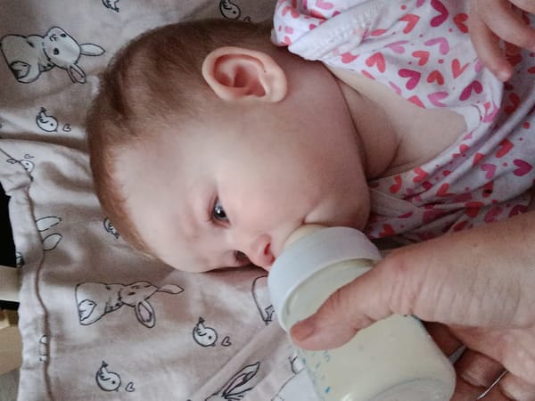 Baby bottle-fed on patterned surface in Фоки, Russia