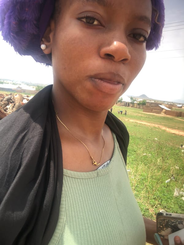 Woman in purple head covering photographed in Nigeria selfie