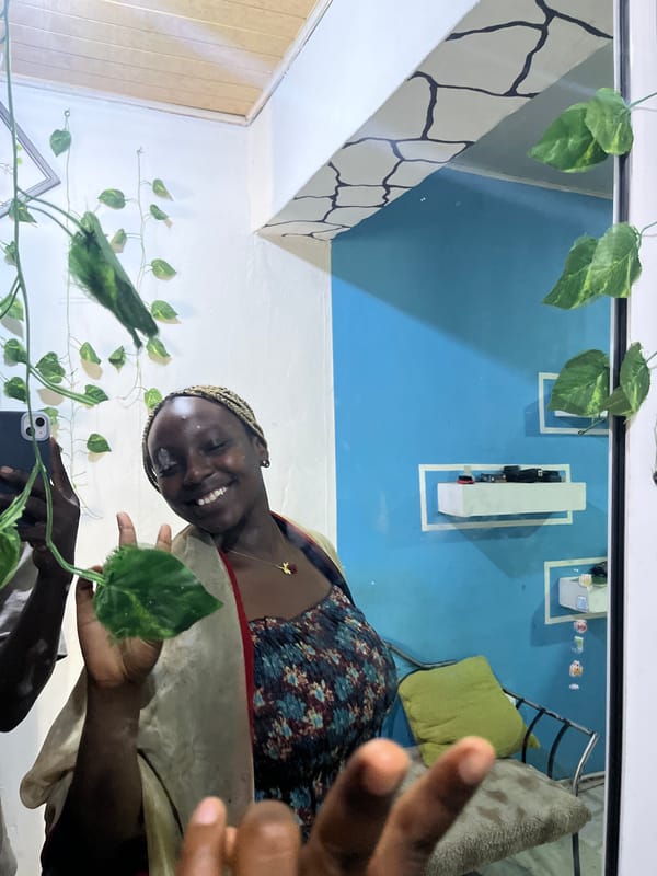 Person takes selfie, makes peace sign in plant-decorated room