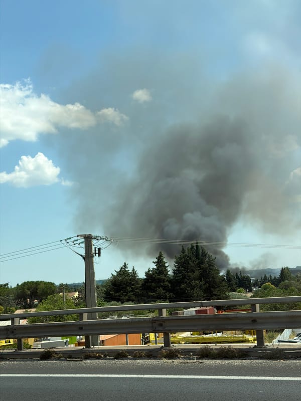 Dark smoke plume rises over Milhaud in midday fire