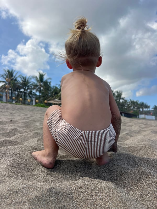 Playing in the sand on a dark-beach Bali morning