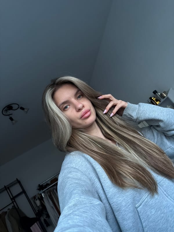 Woman in gray hoodie photographed in Berlin