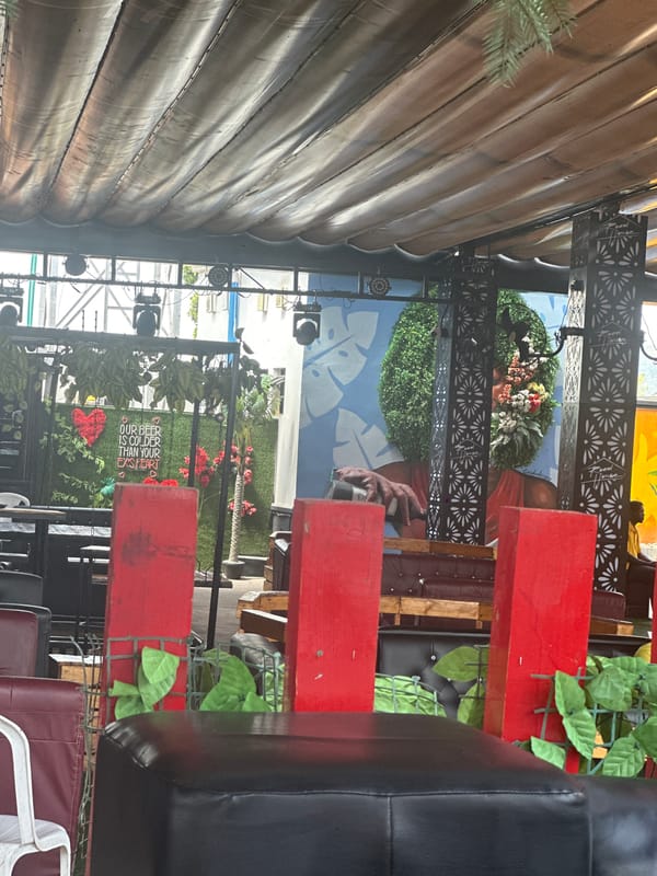 Inside a rustic outdoor bar-restaurant in Howayi, Nigeria