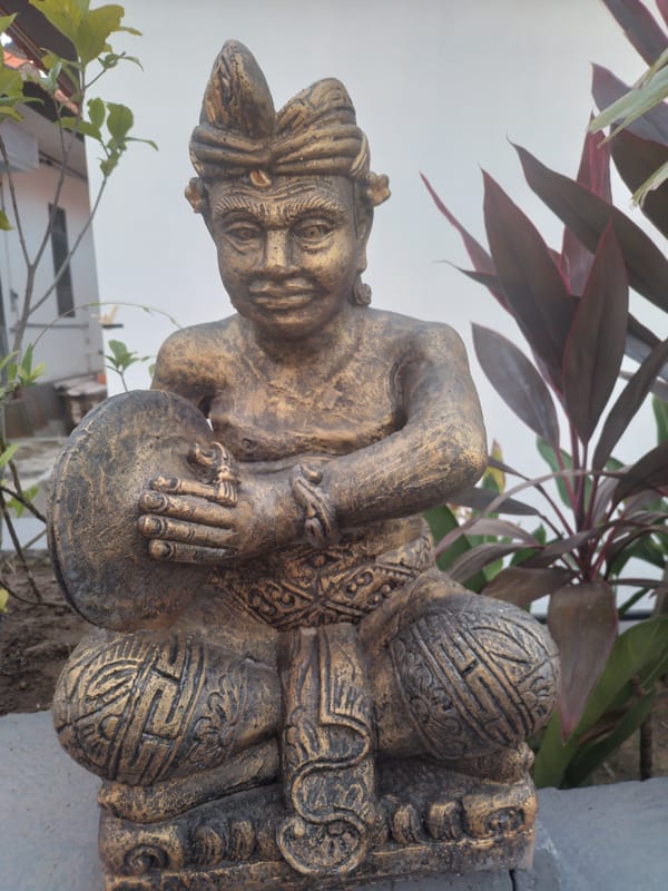 Ornate statue documented amid tropical foliage in Kuta Selatan