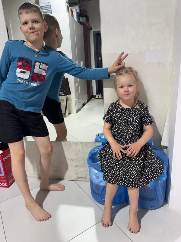 Boy and woman photographed indoors in Gornyi, Russia