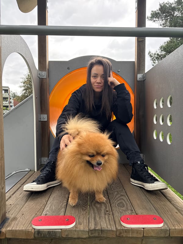 Couple and Pomeranian enjoy Oslo park visit amid children's procession