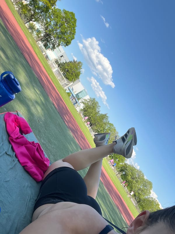 Person rests on track mat with elevated legs