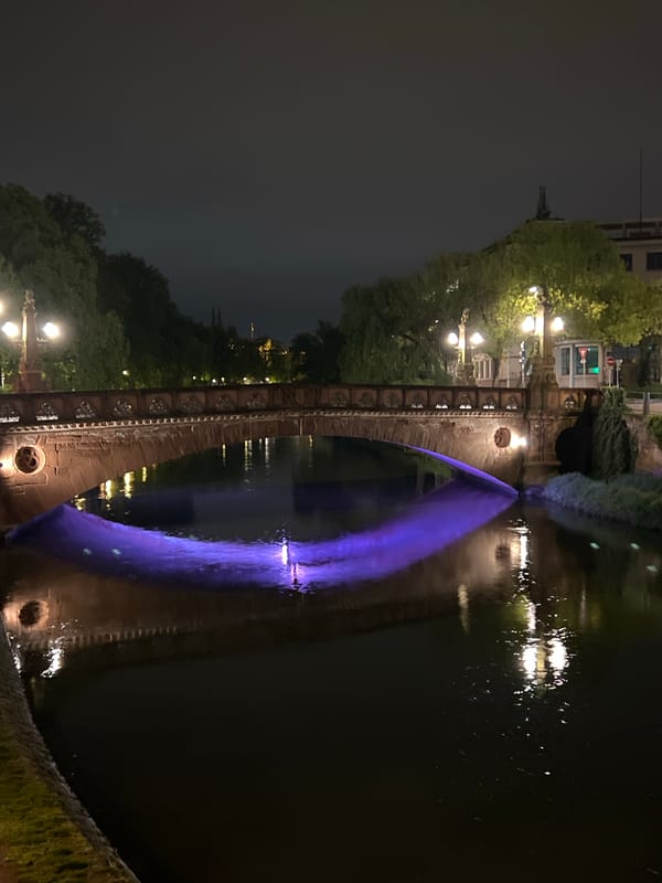 Nighttime scenes captured along Strasbourg's illuminated historic waterways