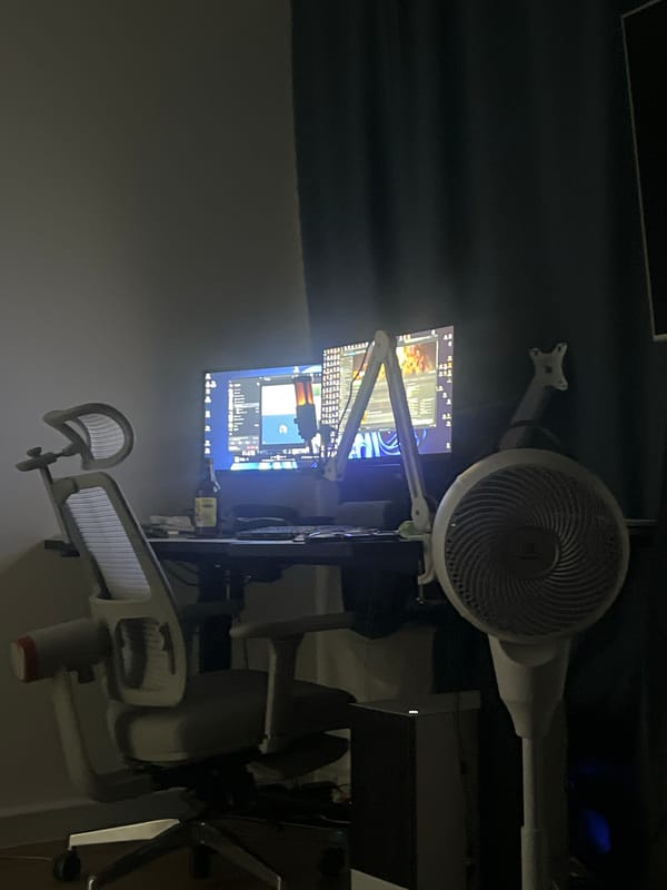 Home gaming setup with dual monitors and PlayStation controller