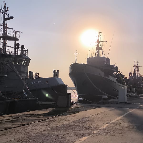 Naval vessels docked at golden hour in Varna harbor