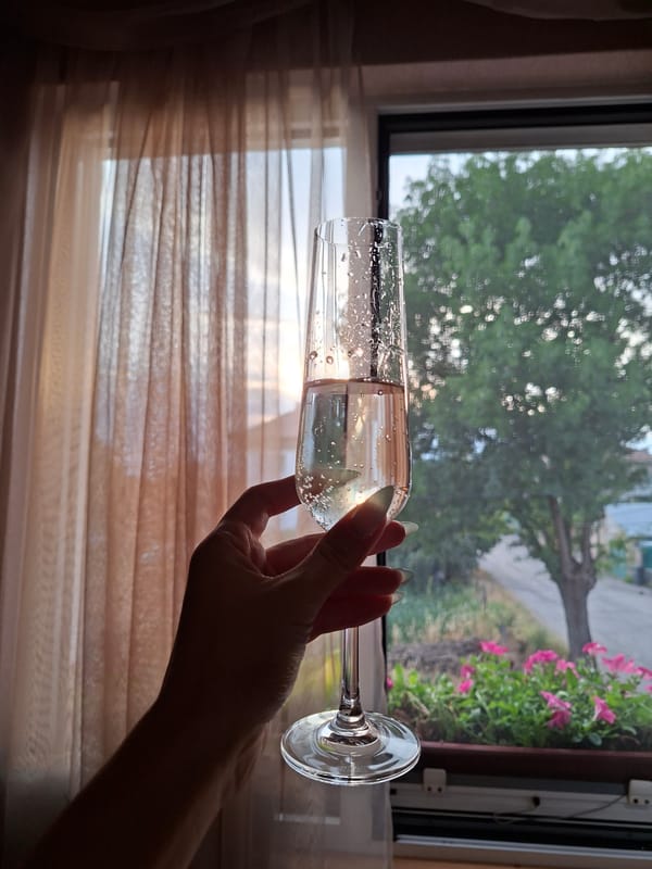 Champagne flute close-up, bubbles and ombré nails