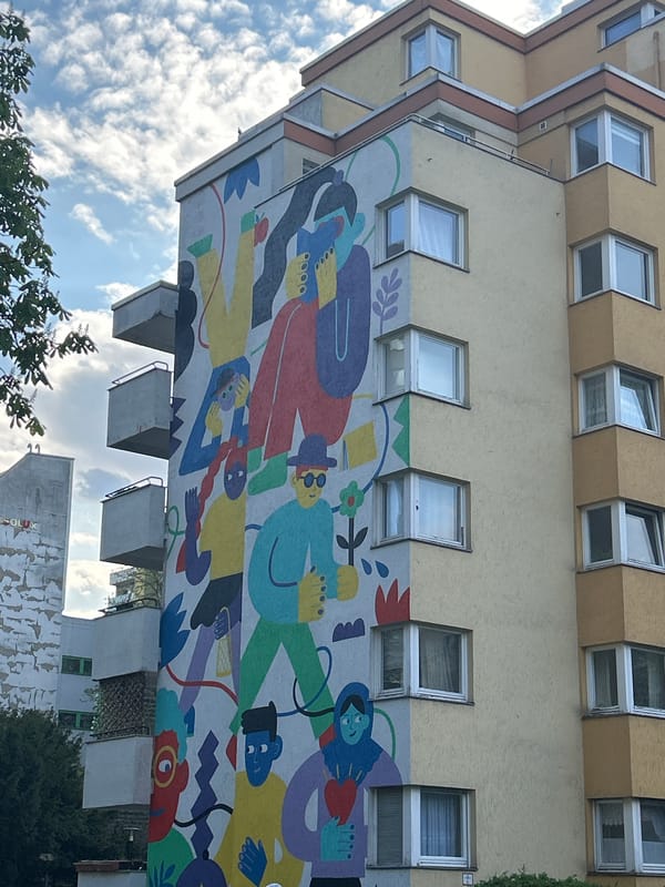 Multi-story building with colorful mural documented by witness