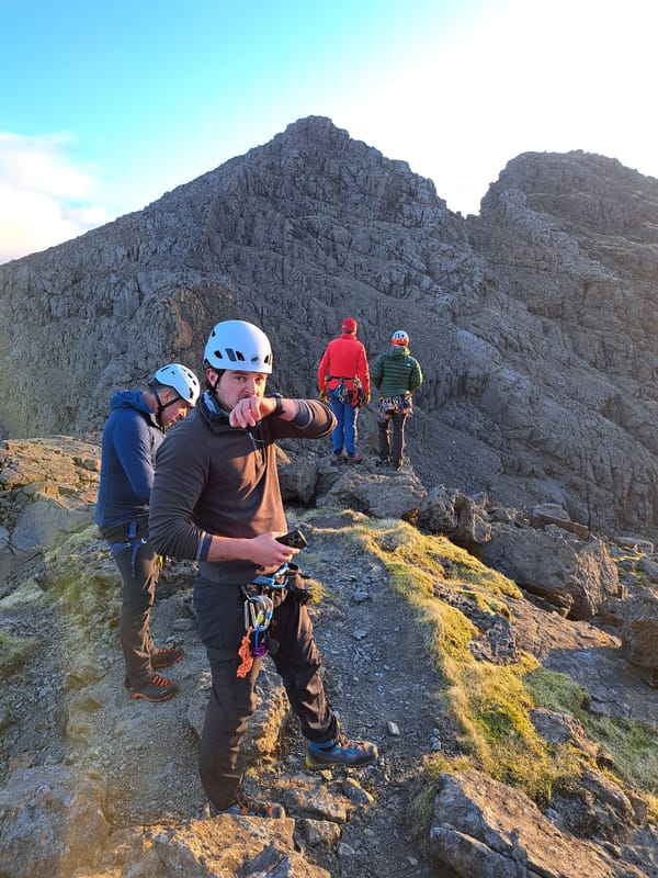 Climbers scale rocky mountainside in Carbost, UK