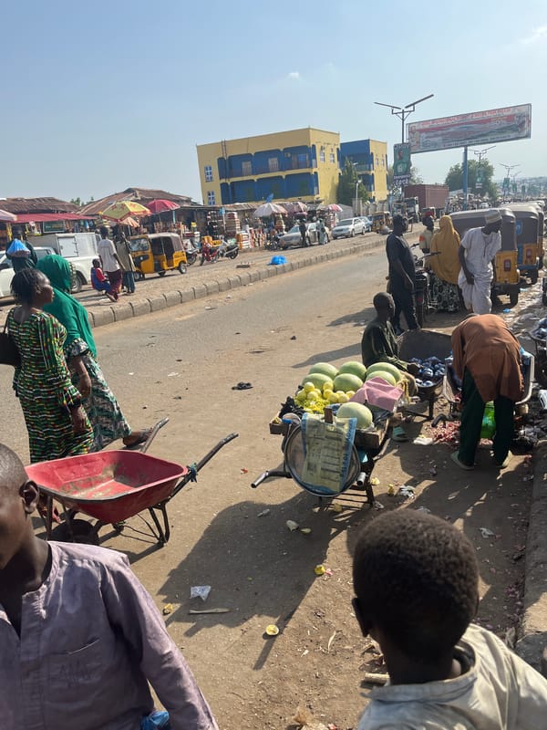 Busy market day captured across multiple vendor stalls in Minna