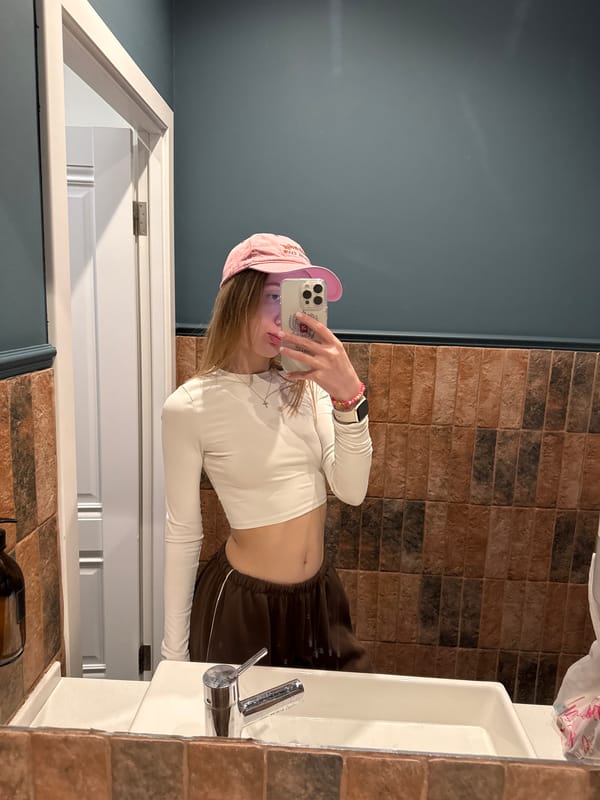 Young person takes bathroom mirror selfie in Rostov-on-Don