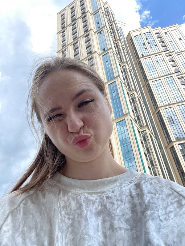 Quick selfie session outside a modern building on a clear day