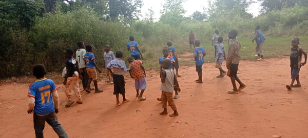 Children gather and play outdoors in Ngalula village