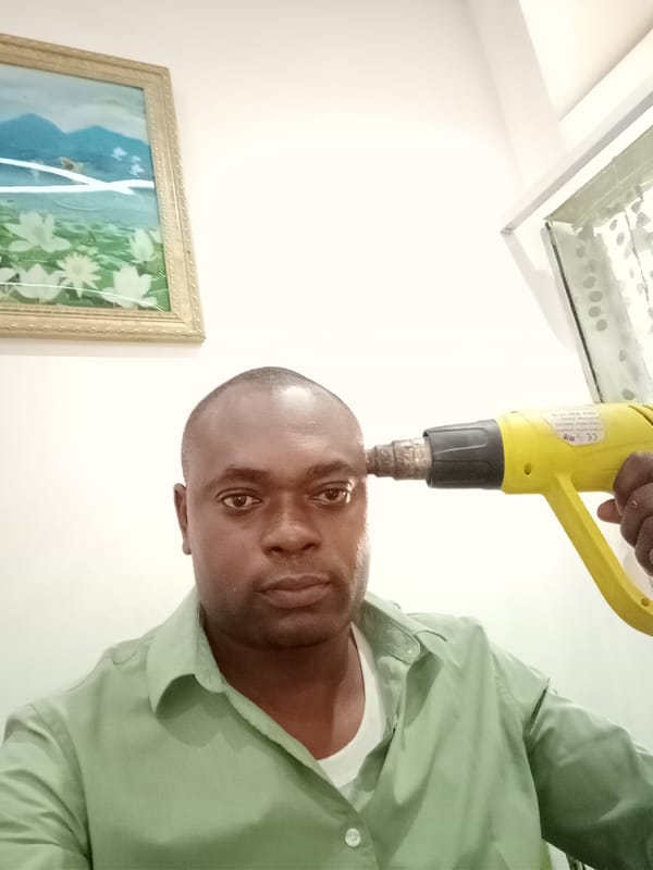 Man documented indoors in Gwarinpa alongside traditional Nigerian meal