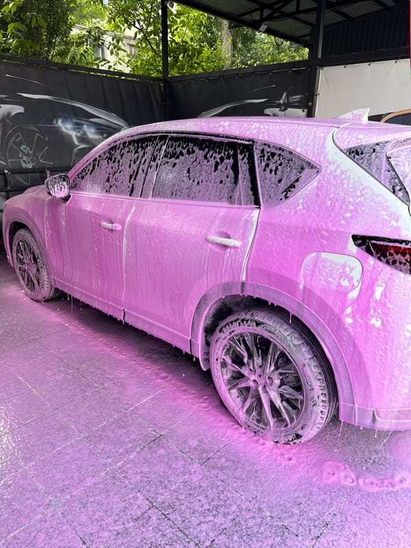 SUV covered in pink foam at a Rozdilna car wash