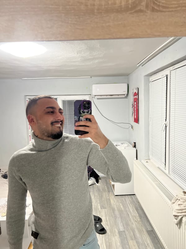 Man takes mirror selfie with purple phone in Shumata