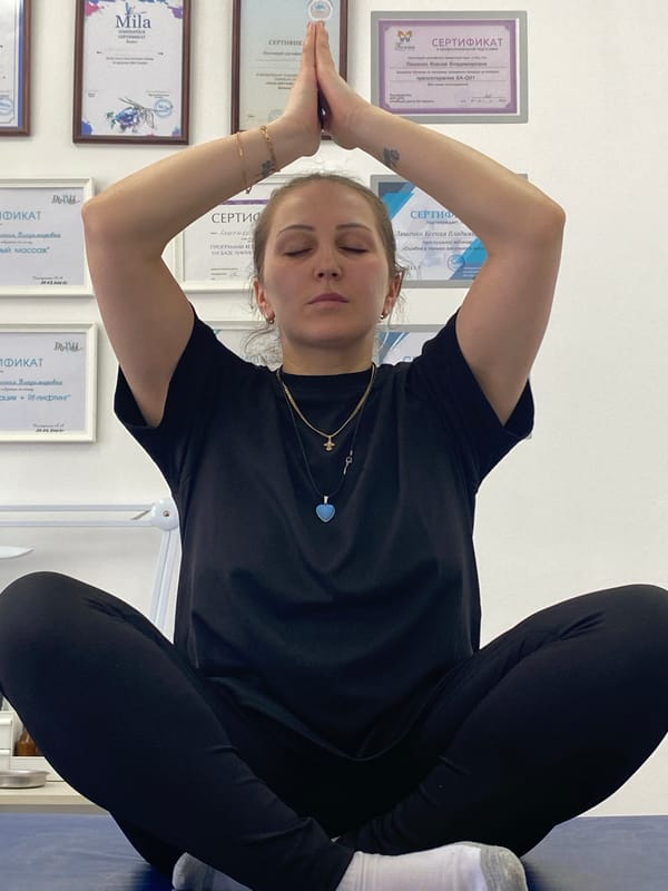 Woman practices yoga pose in Марковский, Russia