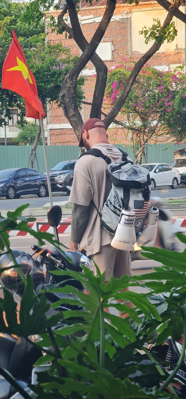 American tourist with motorcycle observed at Da Nang street corner
