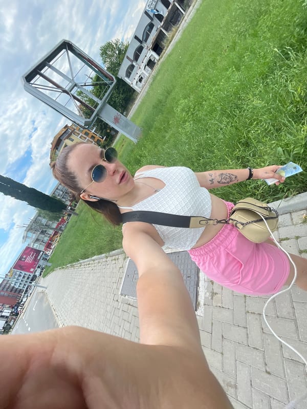 Tourist takes selfie with euro bill in Nesebar