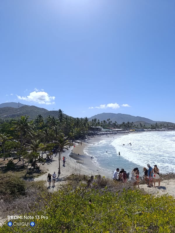 Beachgoers gather at Playa Parguito during sunny evening
