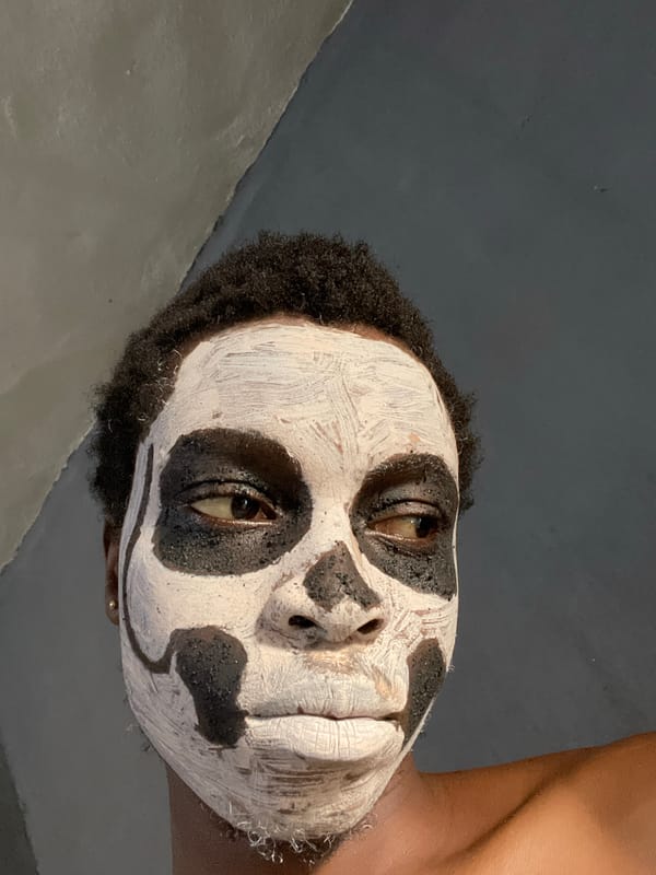 Person poses for skull face paint portraits in Onitsha