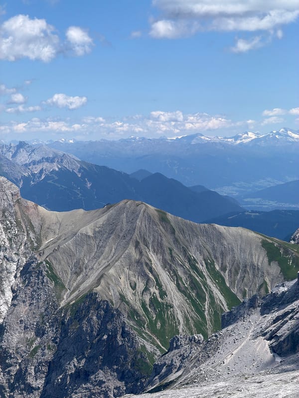 Rocky alpine ridgeline under blue skies near Wildermieming, Austria