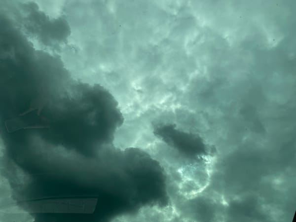 Driver captures stormy skies, unicorn road sign during journey