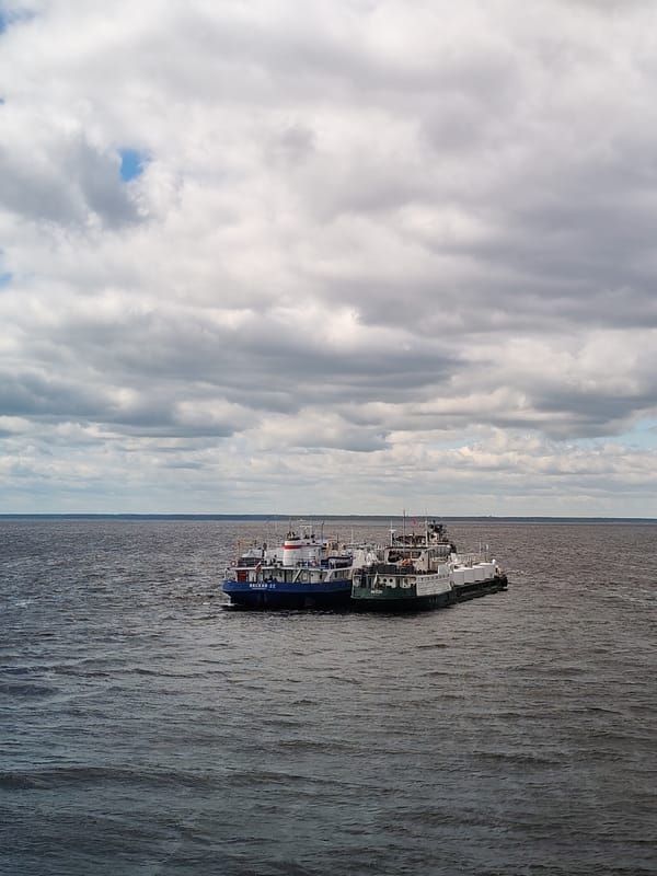 Connected vessels spotted on dark water, observer watches from cabin