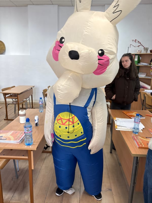 Students celebrate Easter with inflatable bunny costumes in Bulgarian classroom