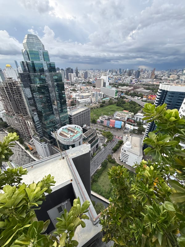 Rooftop views over Bangkok's skyline on a cloudy afternoon
