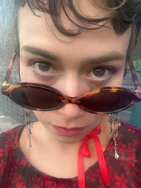Person in sunglasses, floral top photographed in Los Angeles