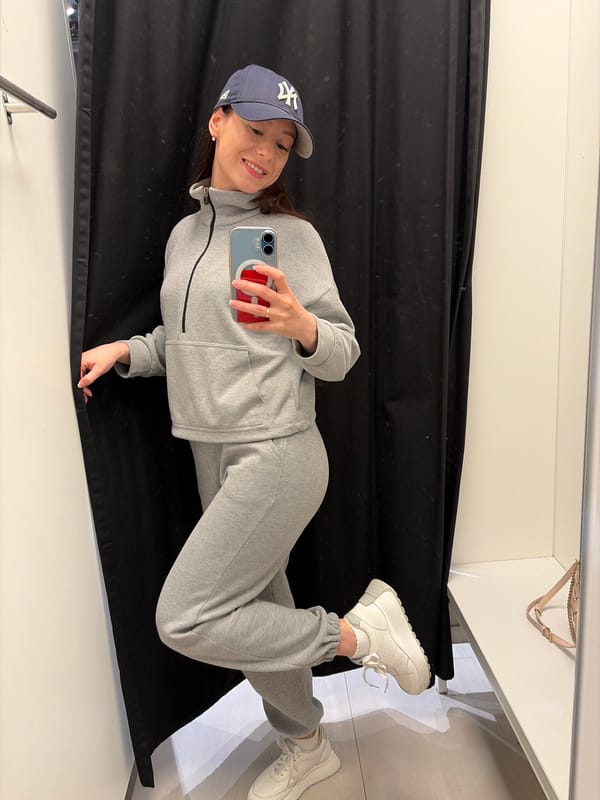 Woman takes mirror selfies near flower display in Япрыково
