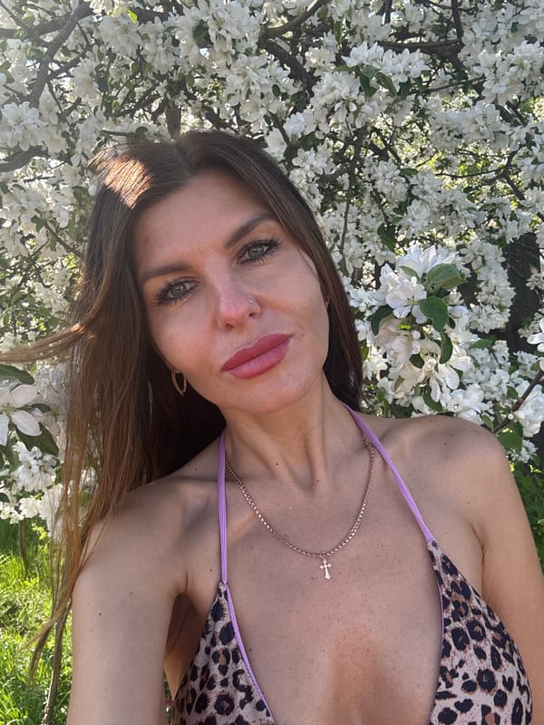 Woman photographs spring blossoms photo session in Dubovaya, Russia