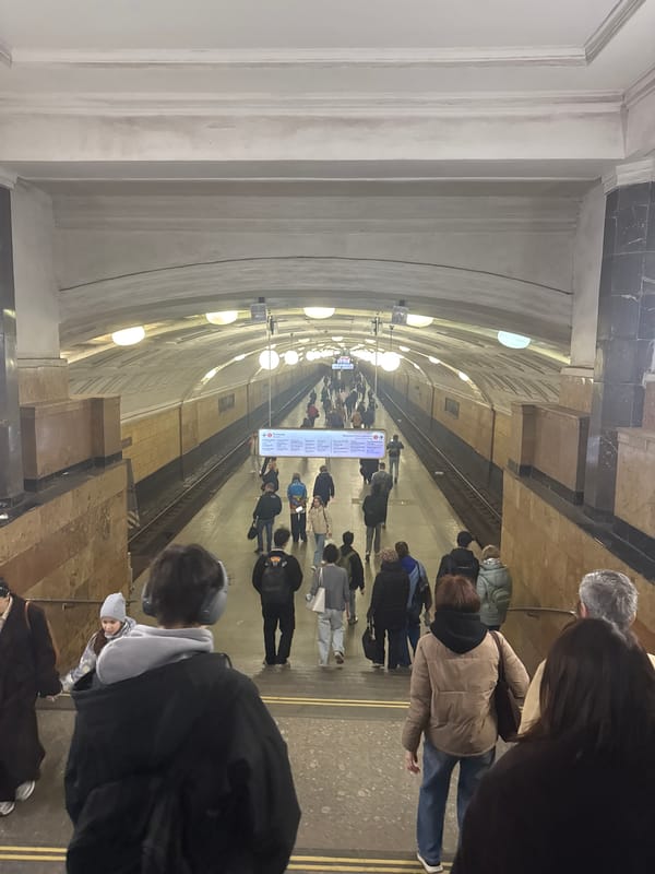 Moscow commuters wait on subway platform during morning rush
