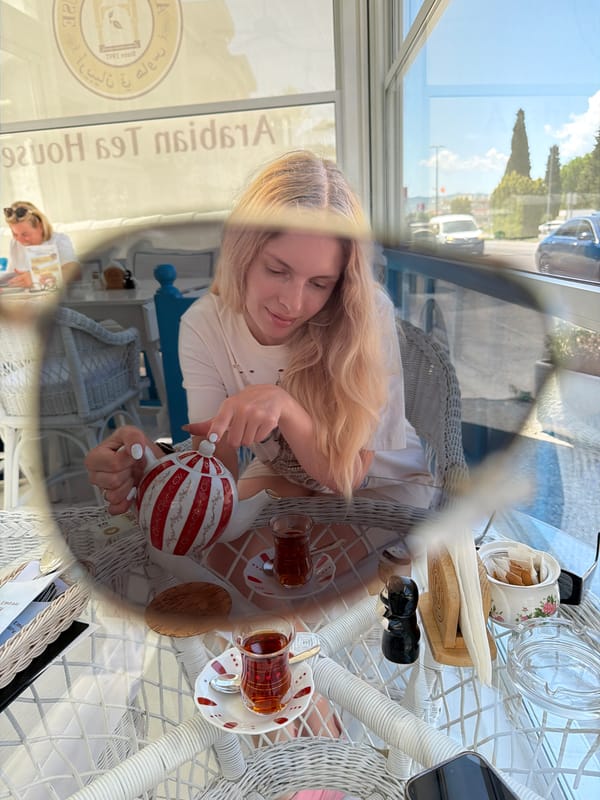 Woman enjoys tea and ceramic figurines at Podgorica cafe